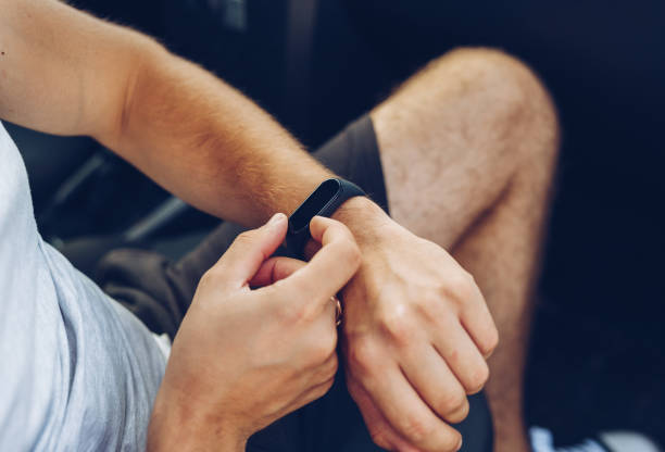 istock Photo of man hands touching  and setting generic design smart watch. 1262310911