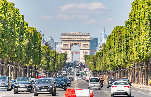 Paris, France. Monday 20 July 2020. Cars and traffic on the busy road Avenue des Champs-Élysées in Paris.