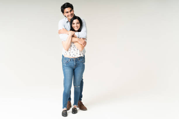 istock Cheerful Young Couple Embracing In Studio 1262313417
