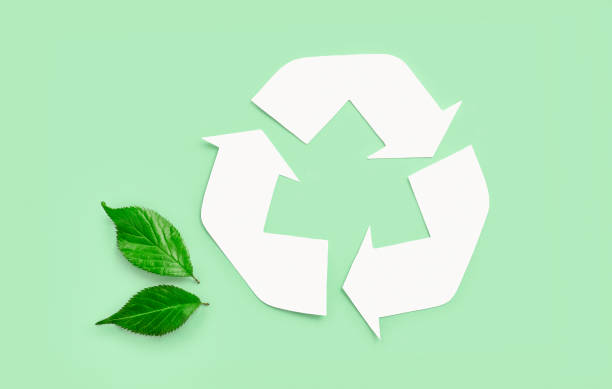istock Recycle eco icon with green leaves on light green background. Top view 1262314007