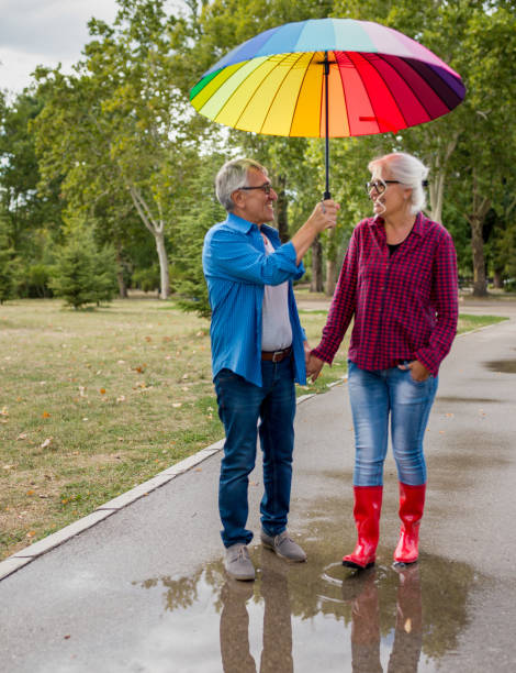 istock Couple walking in wet day 1262316785