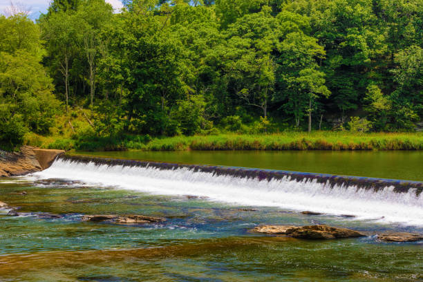 istock Small dam bridges a river in rural Virginia 1262318280