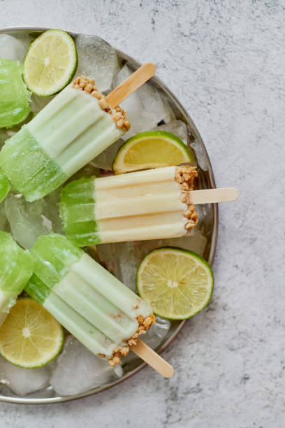 istock Summer refreshing homemade lime popsicles with chipped ice over stone background 1262319053