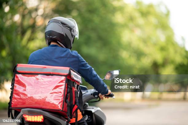 The Staff Prepares The Delivery Box On The Motorcycle For Delivery To Customers Stock Photo - Download Image Now