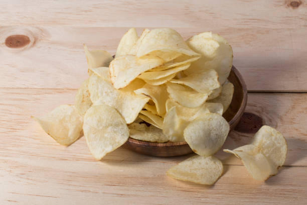istock Close up potato chips on wood top view background. 1262332009