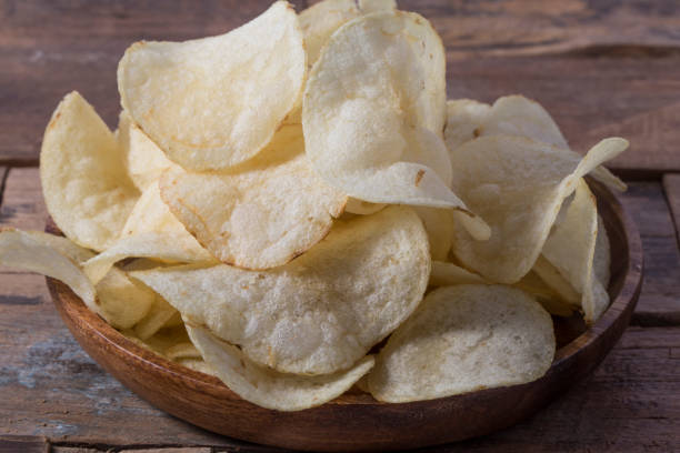 istock Close up potato chips on wood top view background. 1262332025