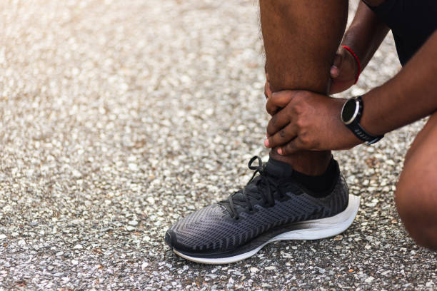 istock sport runner man use hands joint hold leg pain because of twisted ankle broken while running 1262342516