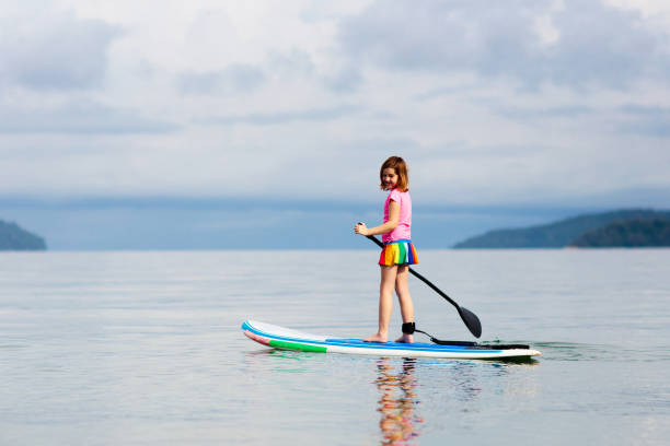 istock Child on stand up paddle. Water and beach sport 1262349417