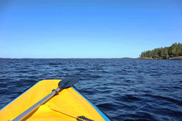istock Rafting adventure yellow boat paddle finish lake 1262349600