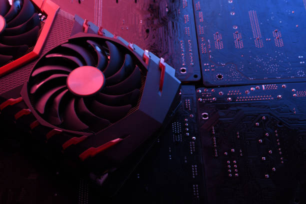 istock Computer game graphics card, videocard with two coolers on circuit board ,motherboard background. Close-up. With red-blue lighting 1262349612