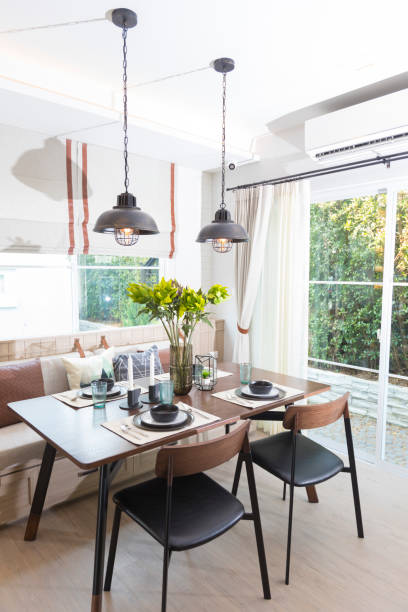 istock Modern loft dinning room with plate setting and hanging lamp 1262352669