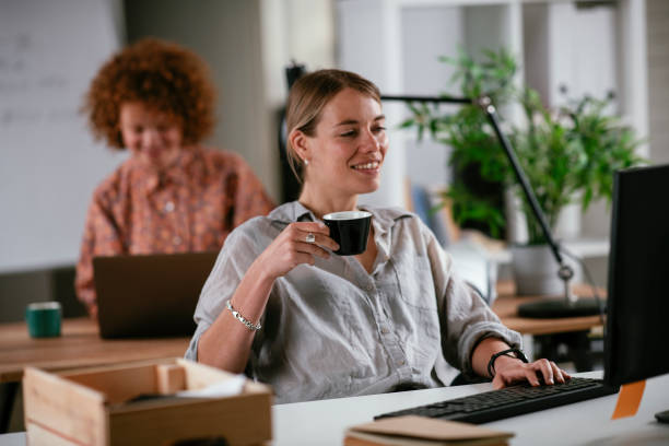 istock Young businesswoman drinking coffee in her office. 1262354485