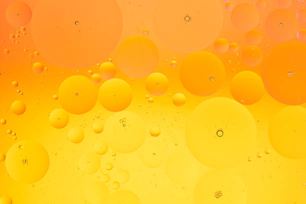 istock Oil bubbles on water macro photography abstract orange and yellow color gradient background 1262358150