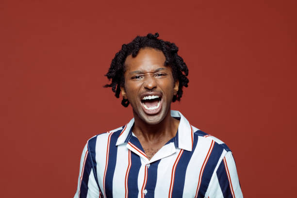 istock Angry young man in retro style striped shirt 1262358912