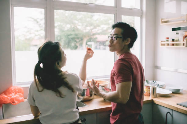 istock a married couple cooking together in the kitchen and having bonding time during weekend 1262360450