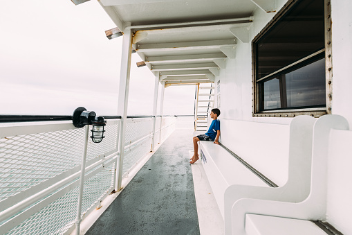 Boy looking at the view on free public ferry service to the Outer Banks in North Carolina.