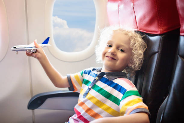 istock Child flying in airplane. Flight with kids. 1262361877