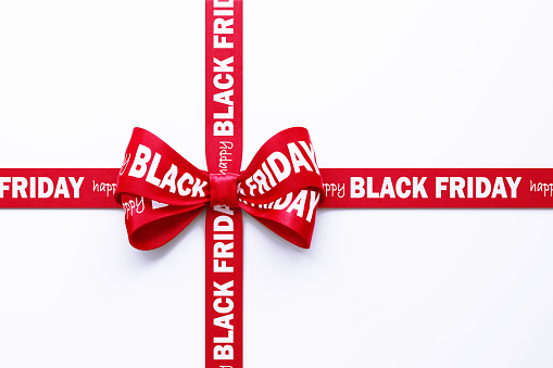 Happy Black Friday written red Tied Bow over white background. Horizontal composition with clipping path and copy space. Black Friday concept.