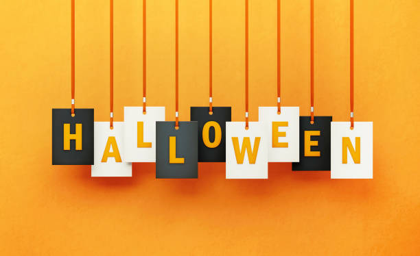 istock Halloween Written by Hanging Letters over Orange Background 1262375237