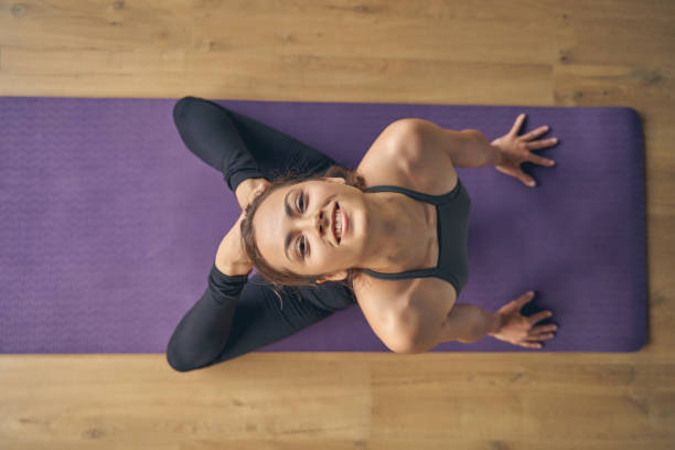 istock Joyful young woman doing backbend yoga pose 1262376417