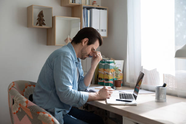 istock Tired man take off glasses suffering from blurry vision 1262376621