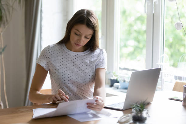 istock Young woman calculate manage finances using laptop 1262378734