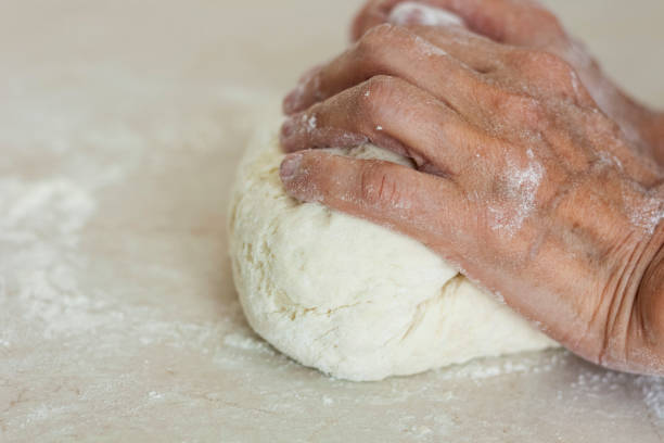 istock women's hands kneading making dough for dumplings. 1262379841