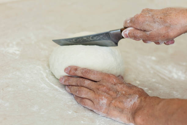 istock women's hands kneading making dough for dumplings. 1262379866