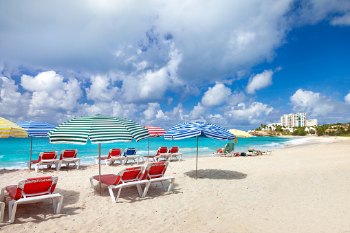 lounge chairs and umbrellas on the beach at Mullet Bay, St.Martin, dutch west indies