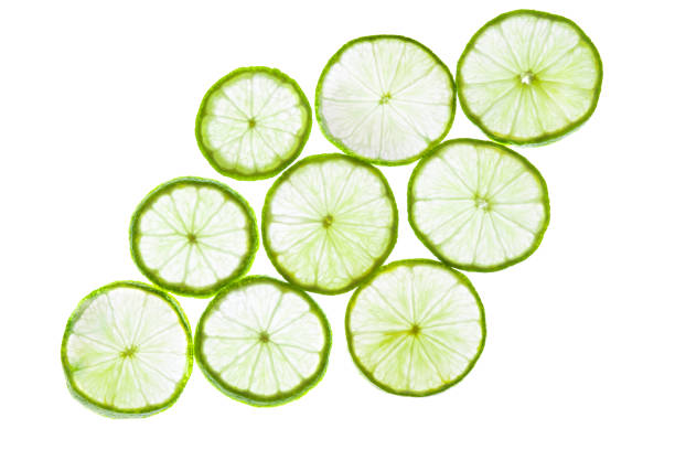 istock Green lime slices isolated on white background. 1262383593