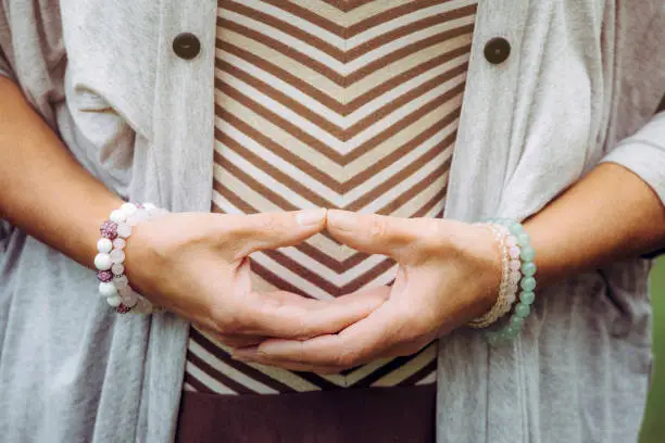 Close up view of woman hands doing meditation Dhyana mudra gesture also known as Samadhi mudra.