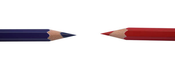 istock Red and blue colored wood pencil crayons facing each other on a white paper background 1262383914