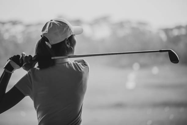 istock Asian young female golfer teeing off and swing her driver at golf driving range 1262384041