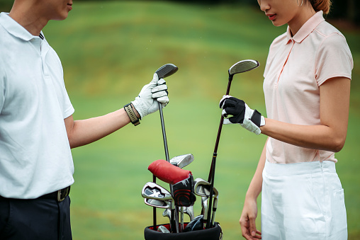 getting ready with hand holding golf driver club during rainy day