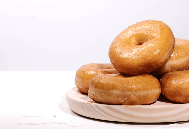 istock wooden tray with many doughnuts on a white background 1262390392