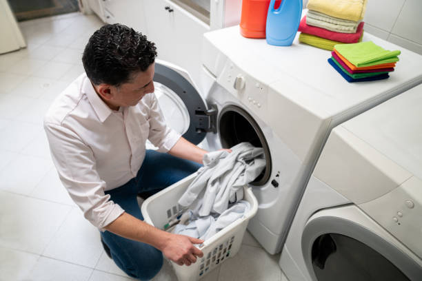 istock Adult man at home doing the laundry 1262396271