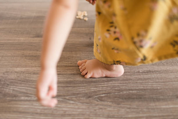 istock 16-Month-Old Girl's Toes & Hands While Eating & Playing 1262396384