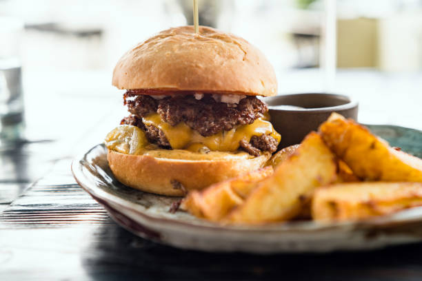 istock Beef burger with fries on a table 1262397239