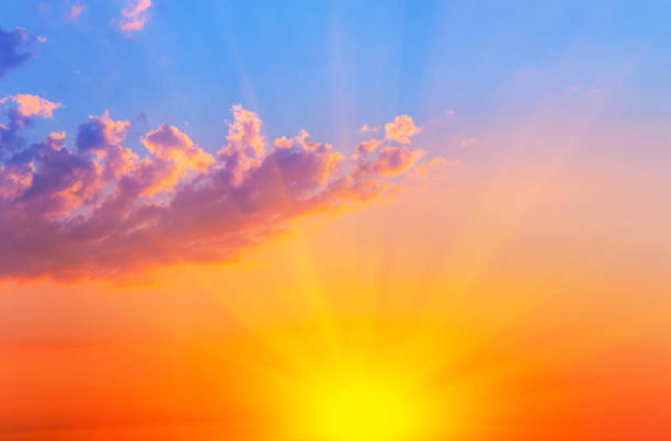 istock Orange with blue sky with bright sun and clouds 1262397343