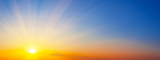 istock Panorama of dramatic sunset sky with sunbeams 1262397387