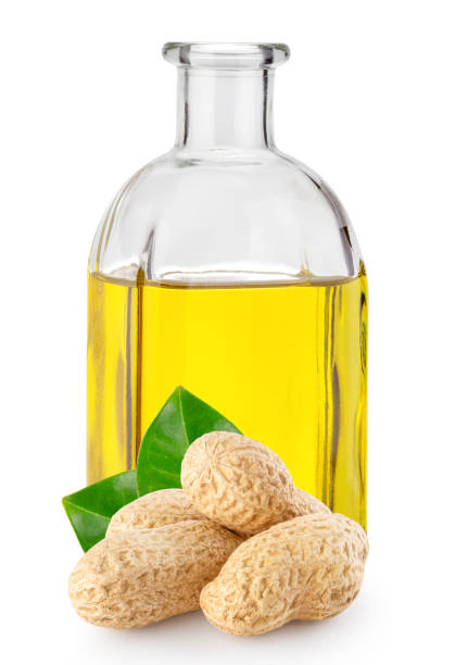 istock Peanuts with leaves and peanut oil in square bottle 1262397396
