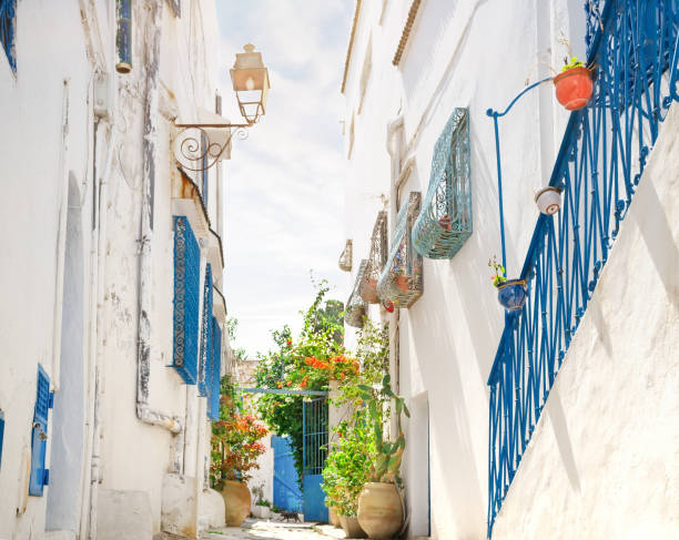 istock Street with white and blue houses under bright sun 1262397506
