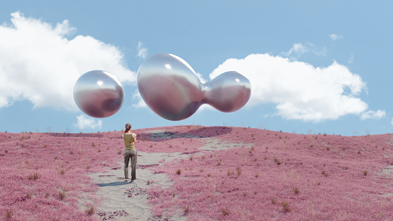 Woman looking at mysterious metallic drops in the sky on an alien world. All objects in the image are 3d