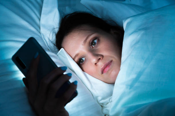 istock Checking apps before sleeping - woman use smartphone at night 1262399946