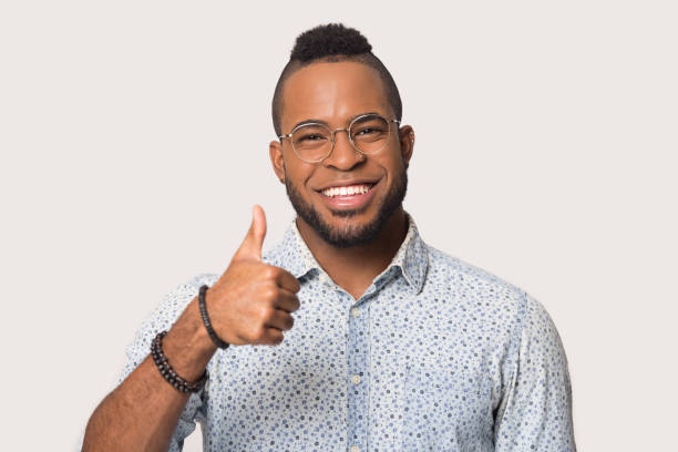 istock Smiling black male show thumb up recommending service 1262402094