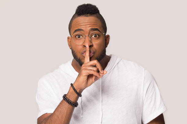 istock African American man make hush gesture isolated in studio 1262402112