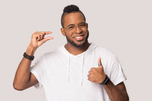 istock Smiling black man demonstrate small prices recommending service 1262402120