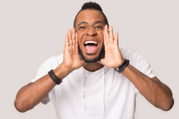 istock Excited black man isolated in studio scream announce sales 1262402127
