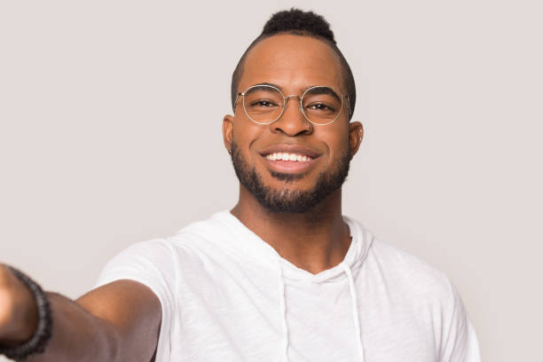 istock Smiling black man in glasses make selfie in studio 1262402135
