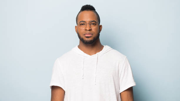 istock Portrait of serious black man isolated on blue studio background 1262402847